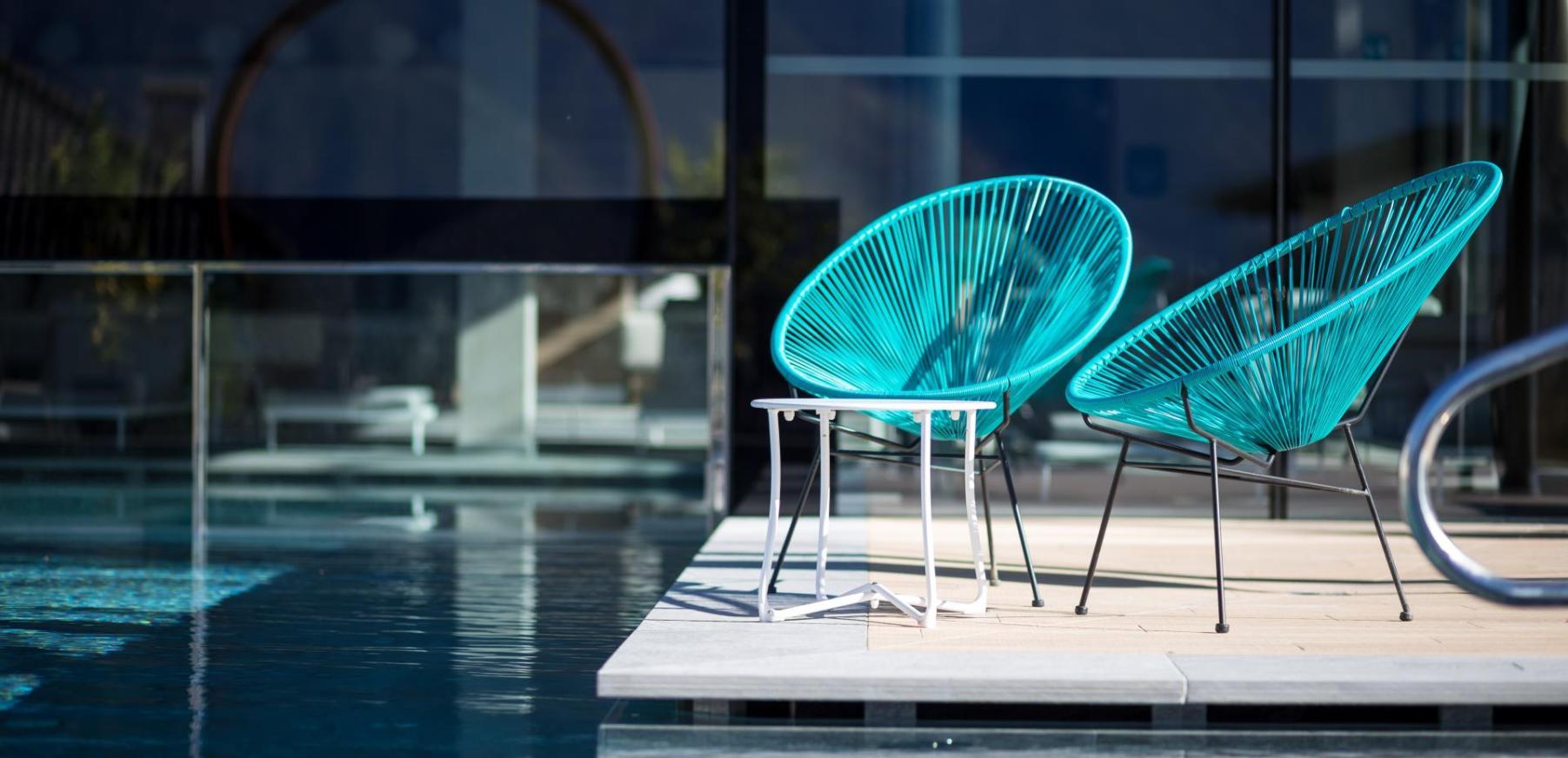 Blue chairs at the poolside