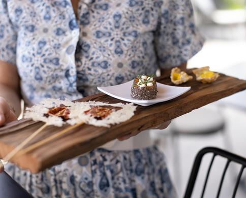 A waitress serves the starters
