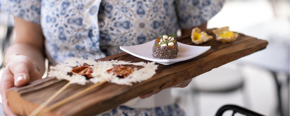 A waitress serves the starters
