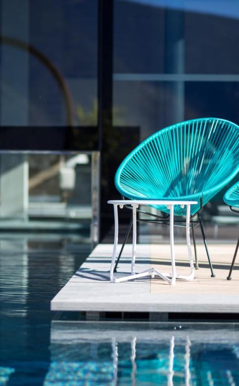 Blue chairs at the poolside