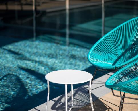 Blue chairs at the poolside