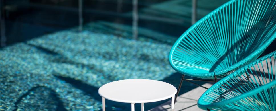 Blue chairs at the poolside